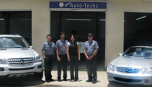 The team with two Mercedes-Benz vehicles at the service bays